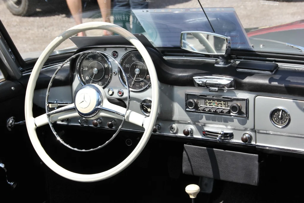 Classic car being loaded onto an open transport trailer